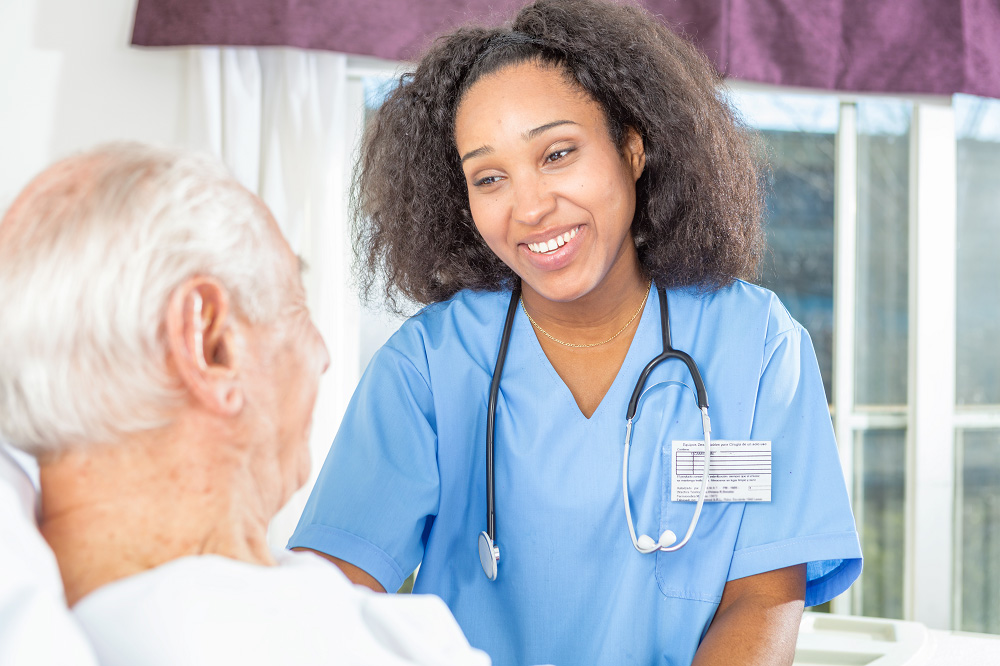 A young doctor is talking to an older man